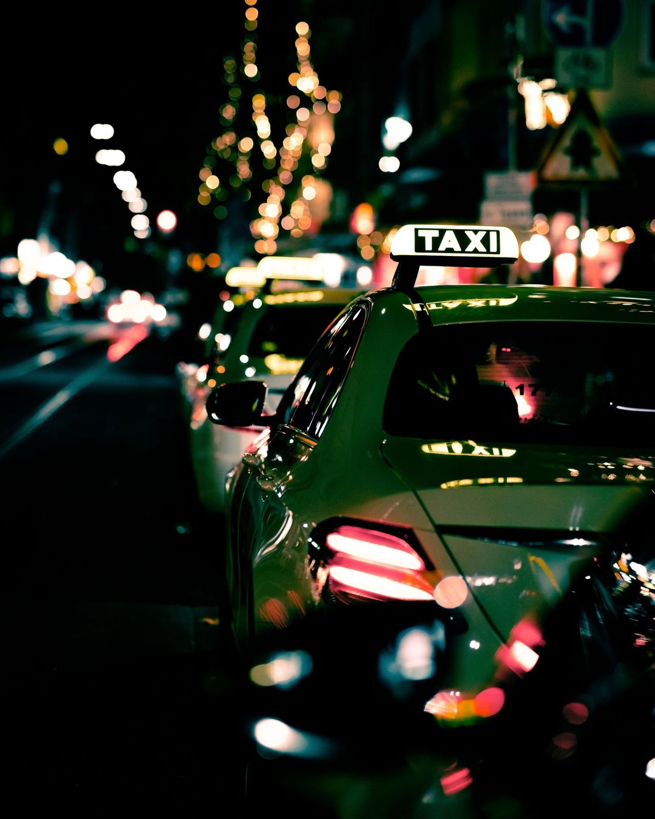 Taxi on a city street at night